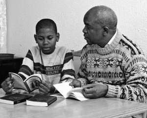 Photo of a man reading with a child. Flickr Creative Commons image from: More Good Foundation: https://flic.kr/p/aqDAUE