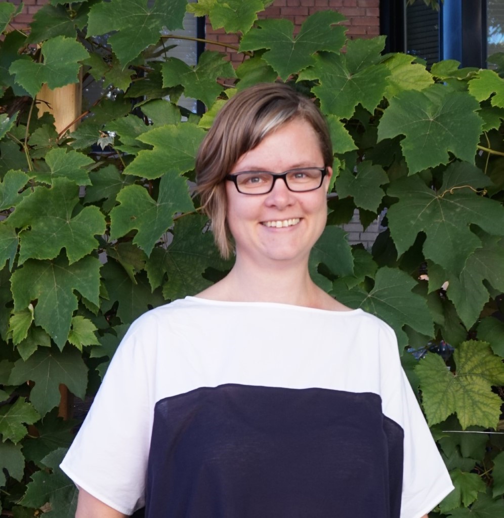 A person smiling for the camera

Description automatically generated