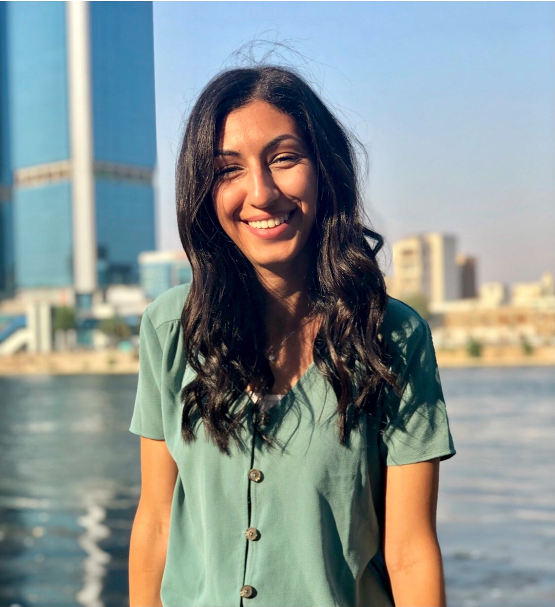 A woman in a green shirt smiling